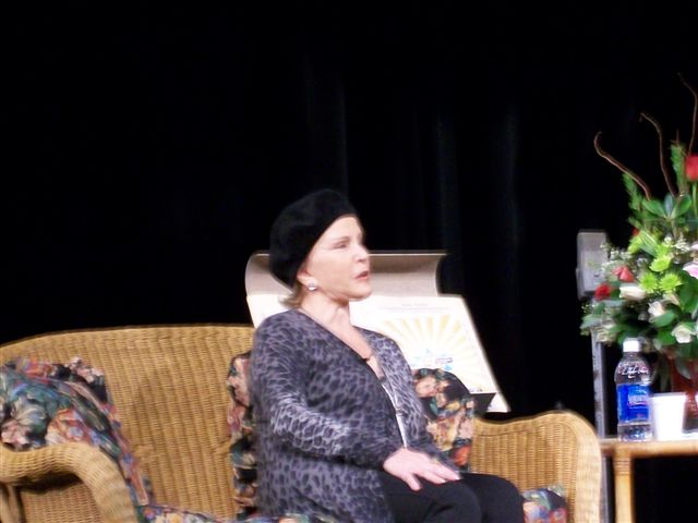 Maria Elena Holly talking at a symposium at the school auditorium.jpg